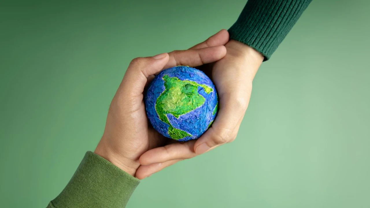 Close up on a plate of mashed potatoes, topped with baked pork chops with cream of mushroom soup, and a side of green beans.
