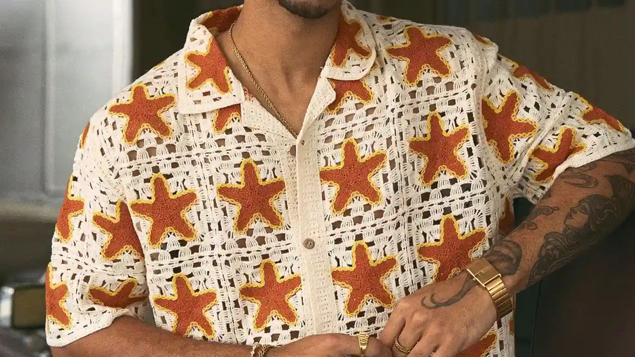 Close up on a plate of mashed potatoes, topped with baked pork chops with cream of mushroom soup, and a side of green beans.